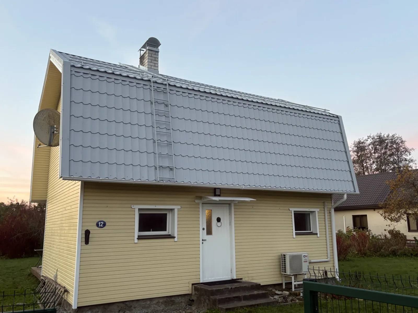 Valmis eramu uue hõbehalli profiilplekk-katusega, hämaruses